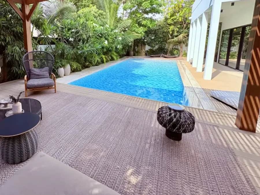 Villa swimming pool beside a timber pergola and tropical planting